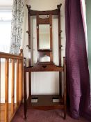 An early 20th Century oak hall stand having art nouveau style design