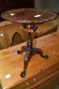 A reproduction mahogany occasional table of small proportions having birdcage design and trefoil