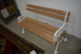 A traditional garden bench having cast ends and new slats, width approx. 125cm