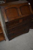 A vintage oak bureau in the Priory style