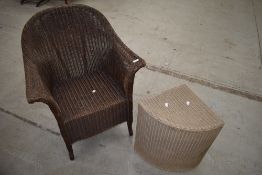 A vintage Lloyd Loom tub chair and corner linen basket