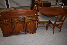 A modern extending dining table with four chairs by Neeson brothers with a matching side board