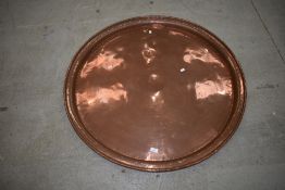 A very large antique copper tray, diameter approx. 99cm