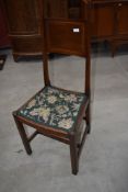An Edwardian mahogany bedroom chair having inlay to solid back with tapered supports