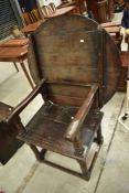 An 18th Century and later oak monks seat having circular tilt table top, diameter approx. 91cm