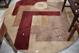 A modern circular rug, in beige and burgundy, diameter approx. 175cm