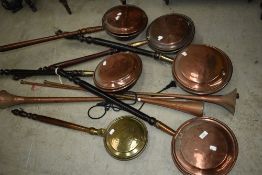A selection of antique and later bedwarmers and copper post/hunting horns