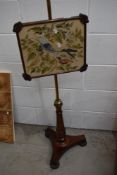 A 19th Century part rosewood pole screen with brass column and embroidered bird panel