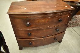 A 19th Century bow fronted chest of three drawers (plus brushing slide) on bracket feet, nice