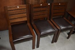 Three modern hardwood and leatherette chairs