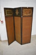 A traditional folding firescreen having linen panels