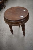 A 19th Century stool or table having triple turned legs