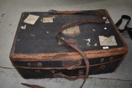 A vintage part leather travel luggage trunk , bearing various vintage labels including British