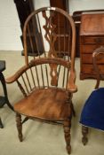 A traditional stained frame Windsor style spindle and slat back armchair