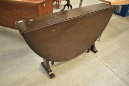 A dark stained Ercol drop gate leg table , in the Sutherland style, open size approx 140 x 12cm