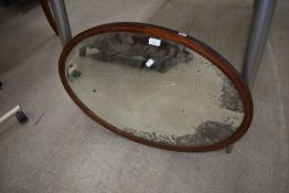An Edwardian oval wall mirror