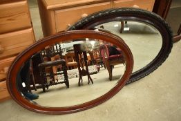 Two vintage oval wall mirrors
