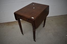 A 19th Century mahogany pembroke table having frieze drawer and turned legs with brass castors