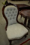 A Victorian button back nursing chair having later upholstery