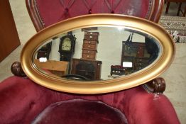 A gilt frame oval wall mirror, approx. 66 x 33cm