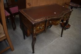 A 19th Sheraton style desk, having serpentine front and shaped legs with extensive inlaid detailing,