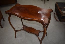 An early 20th Century mahogany occasional table having shaped legs and undertier