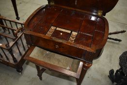 A Victorian walnut sewing table having fitted interior on fluted legs