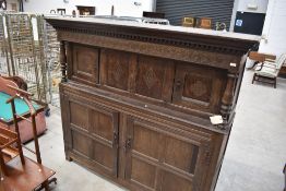 A period oak court cupboard having typical decoration, width approx. 190cm