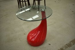 A retro side table having powder coated 'blood drop' red stylised base