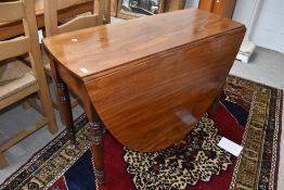 A Victorian mahogany drop leaf dining table having turned legs