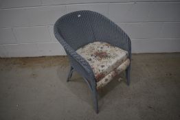 A vintage Lloyd loom tubchair finished in powder blue
