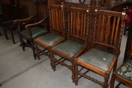 A harlequin set of four (three plus one) early 20th Century oak dining chairs