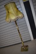 A mid century standard lamp having onyx columns with ormalu