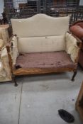 A traditional stripped high back settee having Queen Anne style legs