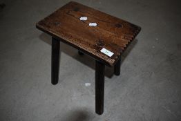 A traditional oak four legged stool