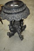 An interesting Oriental plant stand having mythical dragon/sea serpent legs