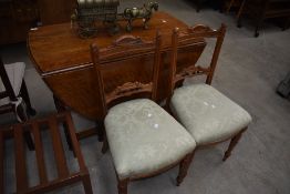 A pair of Victorian parlour chairs in light mahogany with carved and bobbin detail to back, with