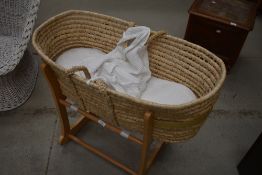 A traditional moses basket on rocking cradle