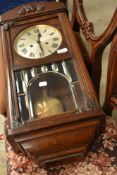 An early 20th Century oak cased wall clock having roman numeral dial