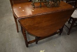 An early 20th Century oak twist gateleg dining table