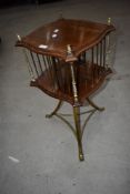 An early 20th Century brass and mahogany revolving bookcase