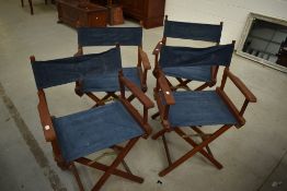 A set of four teak and canvas directors style folding garden chairs