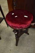 A Victorian mahogany piano stool having adjustable swivel top