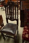 A carved oak salon or hall chair having overstuffed seat