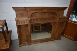 An Arts and Crafts style golden oak over mantel mirror
