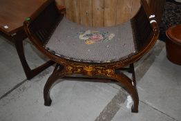 An early 20th Century mahogany and inlaid savanarola style stool having woolwork seat