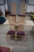 A polished concrete dining table and set of four beech effect high back dining chairs, table