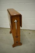 An Arts and Crafts golden oak drop leaf standing table having twist top, in the Arthur Simpson