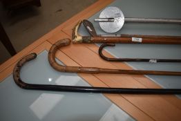A selection of vintage walking canes, shooting stick etc