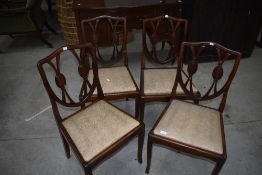 A set of four reproduction dining chairs